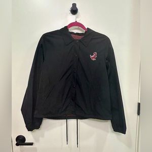 BDG black polyester button up jacket with Dino patch, size M.